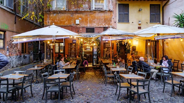 A charming outdoor cafe in a historic Italian neighborhood.