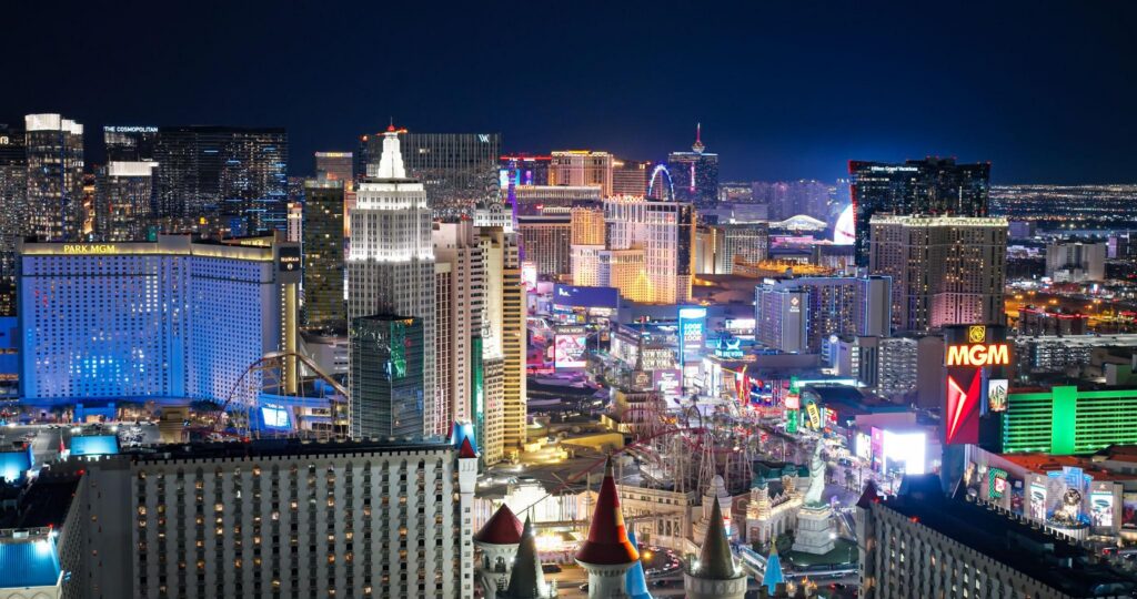 A nighttime view of the Las Vegas Strip, focusing on several iconic resorts