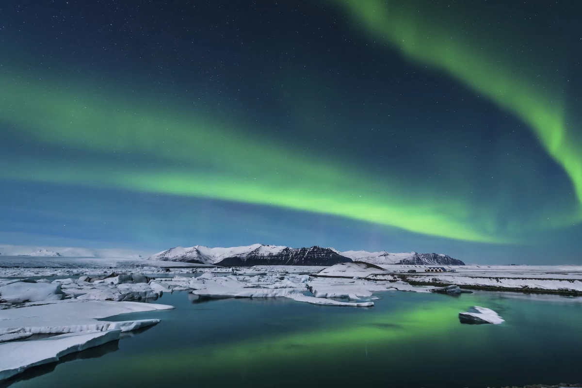 The Aurora Borealis (Northern Lights) dancing over the icy landscapes of Iceland.