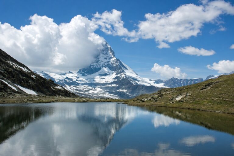 A view of Matterhorn Peak from the Riffelsee Lake with the village of Zermatt located at the foot of the mountain.