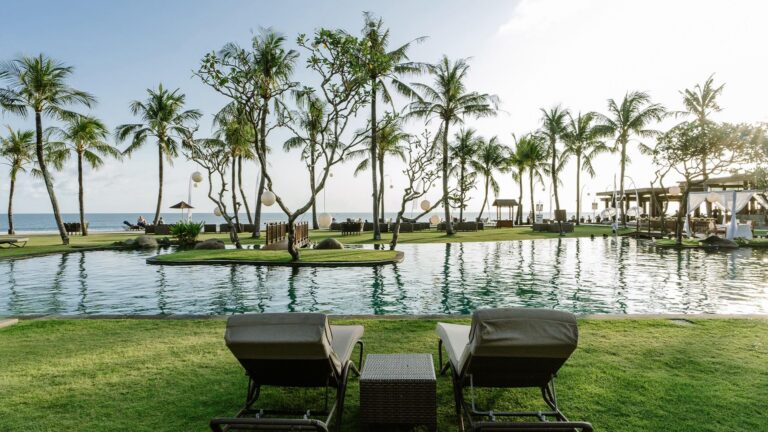 Beachfront infinity pool and tropical gardens at The Samaya Seminyak Bali resort in Indonesia.