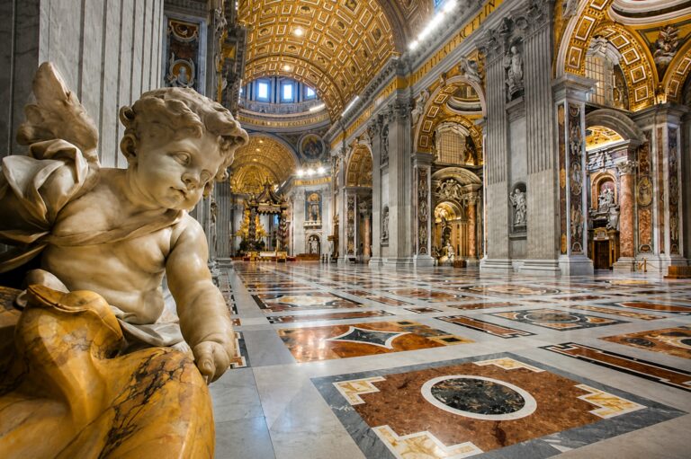The interior of St. Peter's Basilica in Vatican City, featuring a statue of an angel.