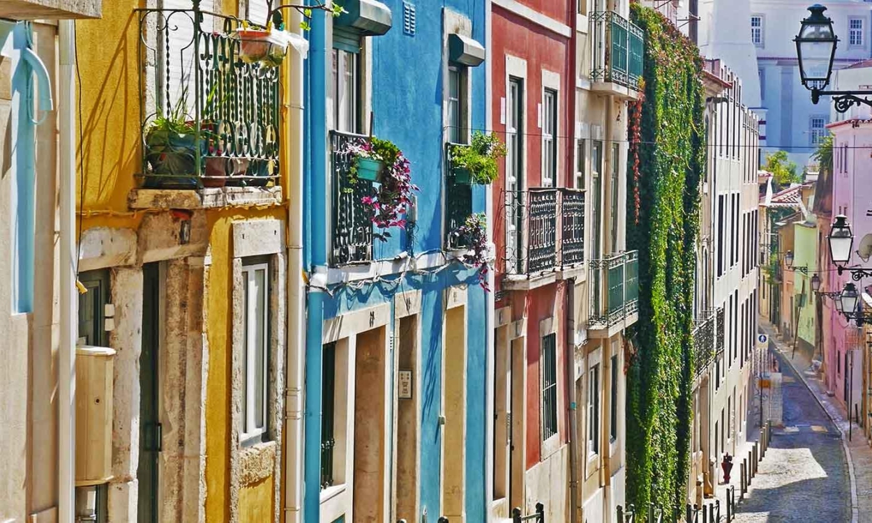 By day, the Bairro Alto neighborhood in Lisbon is a relaxed hub for exploring strikingly colored buildings, tiled homes and small shops, transforming into a vibrant nightlife district after dark.