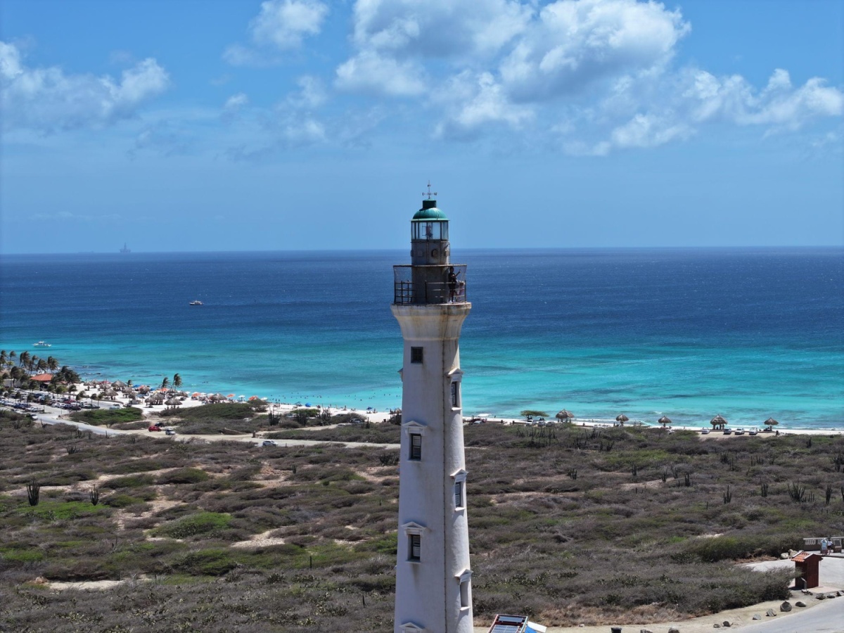 The California Lighthouse in Aruba overlooks the Caribbean Sea, and is a popular scenic viewpoint for tourists.