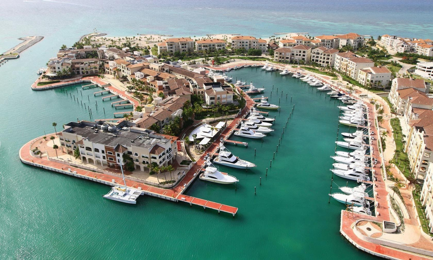 Cap Cana Marina in Punta Cana is a luxury destination characterized by its Mediterranean-style architecture and numerous docked yachts.