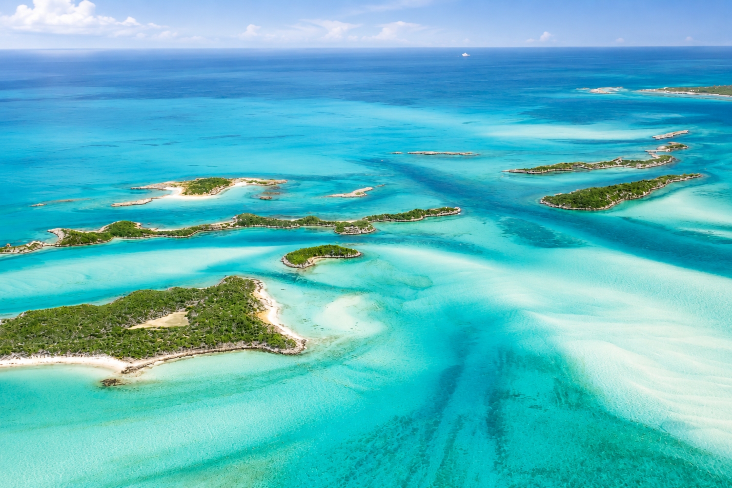 The shallow turquoise waters and small islands of the Exuma Cays in The Bahamas.