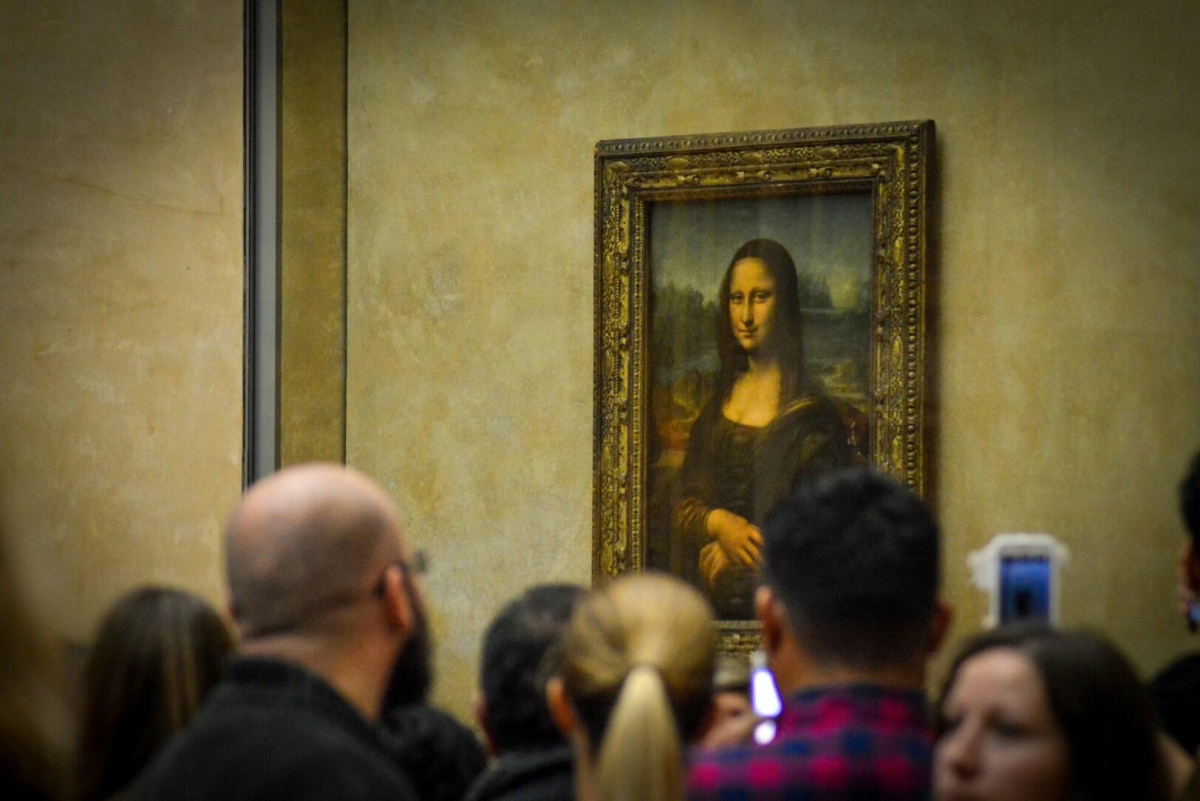 The Mona Lisa, a famous portrait painted by Leonardo da Vinci between 1503 and 1519, displayed at the Louvre Museum in Paris, France.