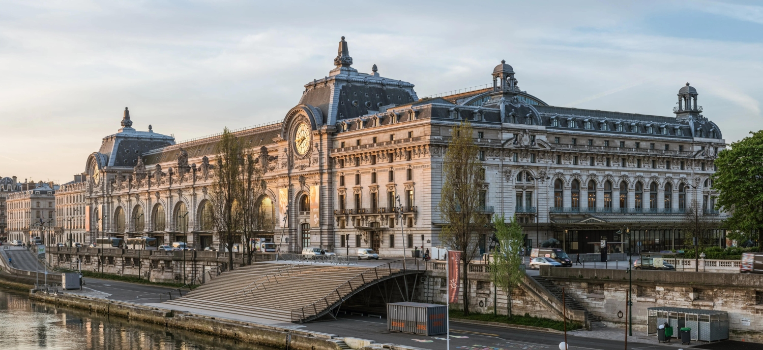 The Musee d'Orsay in Paris is a renowned museum housed in a repurposed Belle Epoque train stationand is famous for its architecture, featuring a massive barrel-vaulted glass ceiling and a golden clock near the entrance.
