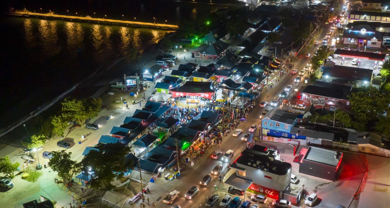 Oistins Fish Fry in Barbados is a popular social gathering featuring freshly cooked local fish, lively music, and a party atmosphere famous for its bustling atmosphere on Friday nights.