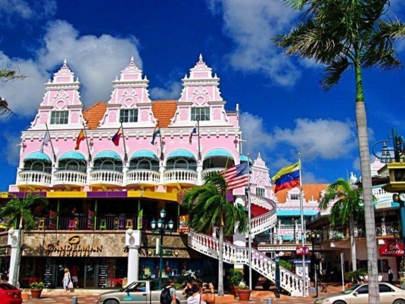 The pink and white Royal Plaza Mall located on LG Smith Boulevard in Oranjestad, Aruba is a shopping center known for its distinct Dutch Colonial architecture.