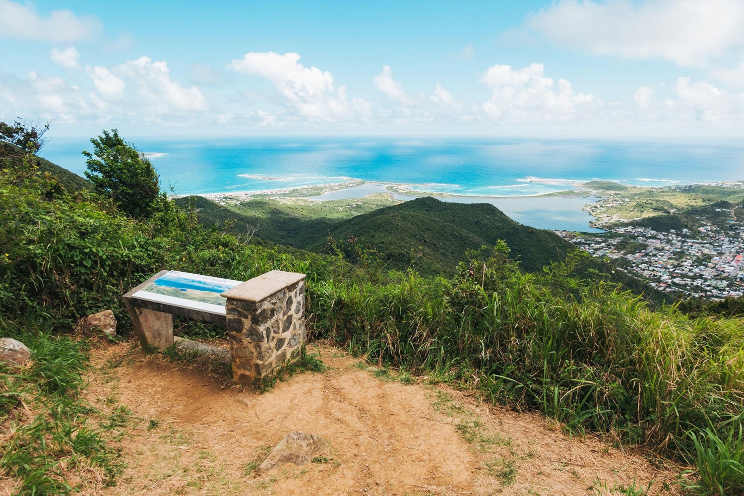 A panoramic view from Pic Paradis, the highest point on the island of Saint Martin in the Caribbean, offers views of neighboring islets and coastal areas like Grand Case and Marigot.