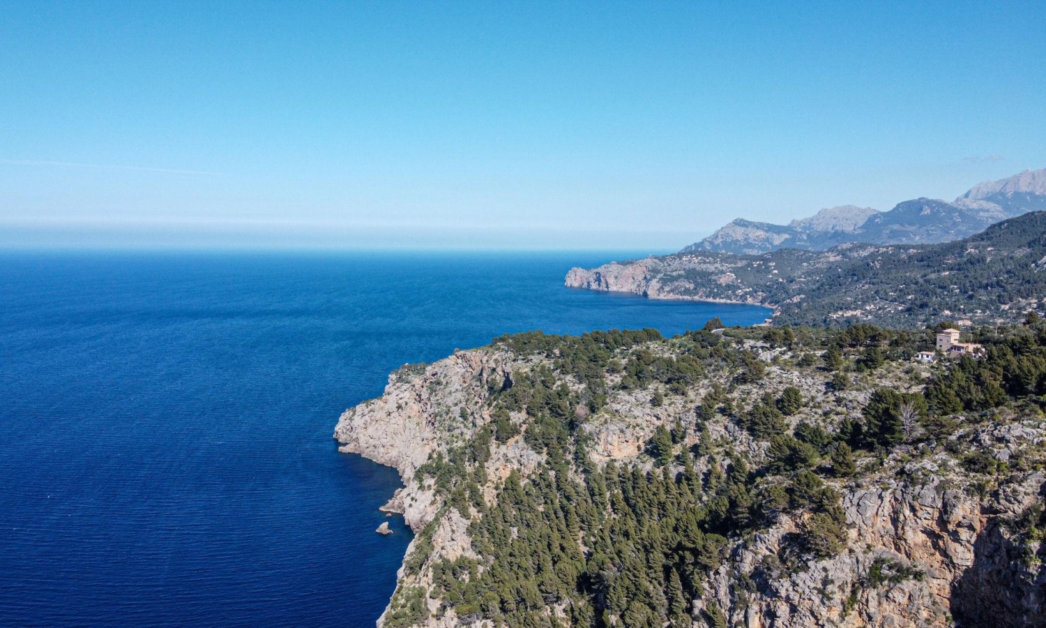 The rugged coastline of Cala Tuent in Mallorca, Spain is part of the Serra de Tramuntana mountain range, renowned for its dramatic landscape and scenic drives.