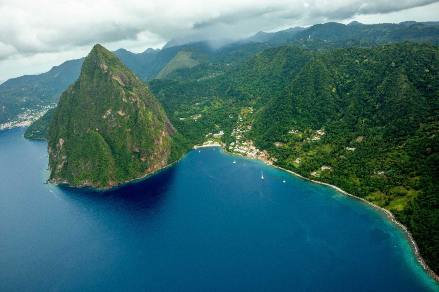 The Pitons are two volcanic plugs that dramatically rise from the turquoise water located near the town of Soufrière on the southwestern coast of Saint Lucia.